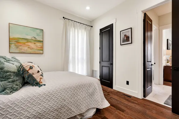 an aerial view of residential houses with yard and mountain view in back