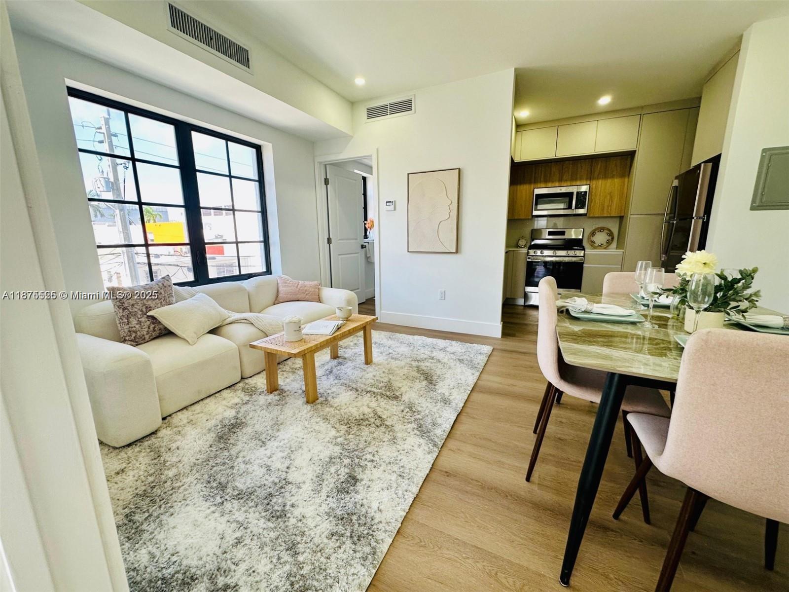 1619 Jefferson Avenue, Unit 104 Miami Beach, FL 33139 - Photo 4 of 6 a living room with furniture and a rug