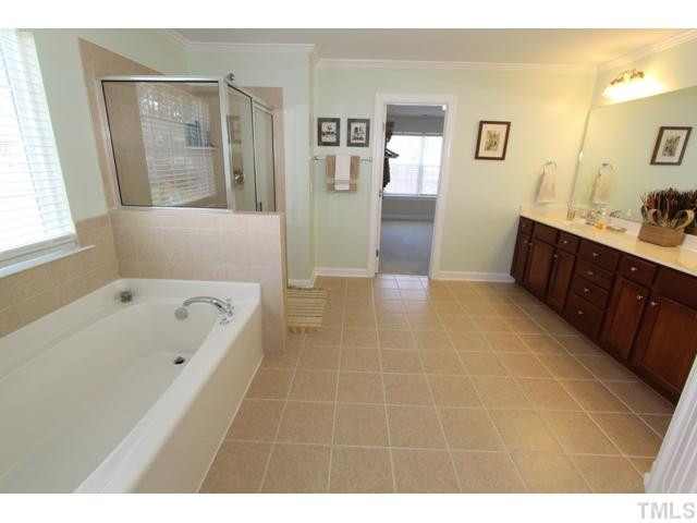 5807 Claribel Court Raleigh, NC 27612 - Photo 14 of 24 Retreat to the master bath with double sinks, tub, separate shower & upgraded tile Master Bath/Spa