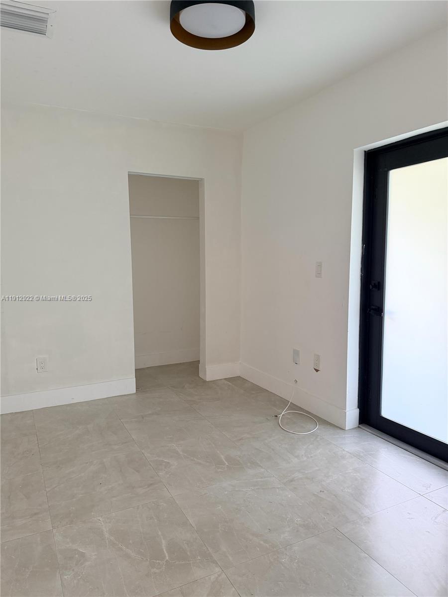 911 79th Terrace, Unit B Miami Beach, FL 33141 - Photo 1 of 9 a view of an empty room with a window
