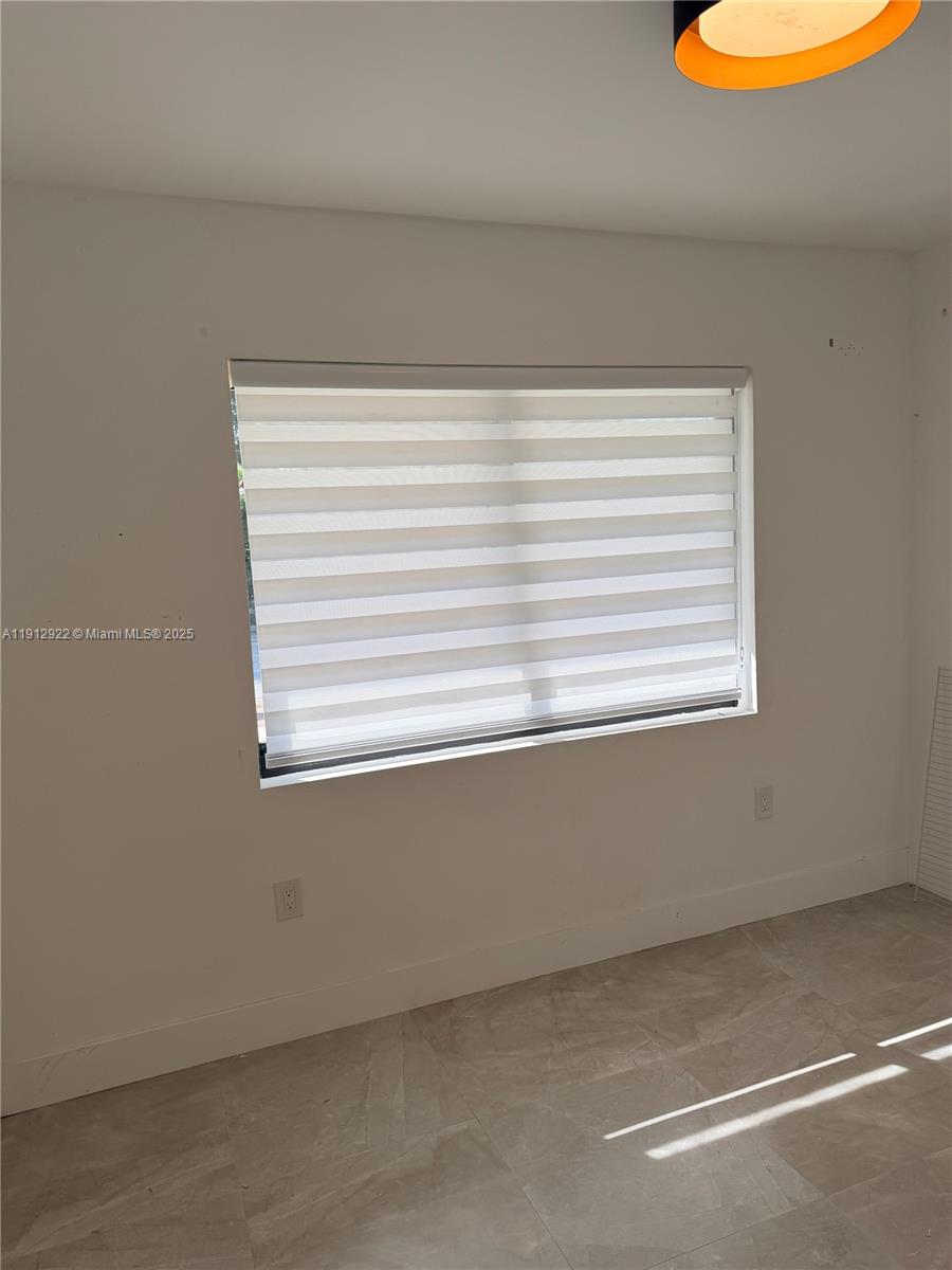 911 79th Terrace, Unit B Miami Beach, FL 33141 - Photo 8 of 9 a view of a window in a room