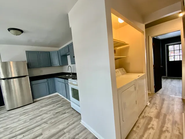 a kitchen with a refrigerator and a sink