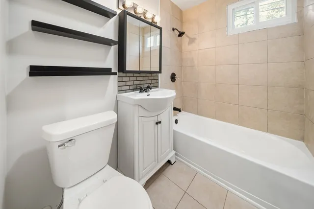 a bathroom with a toilet a sink and bathtub
