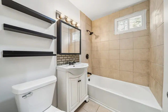 a bathroom with a sink a toilet and bathtub