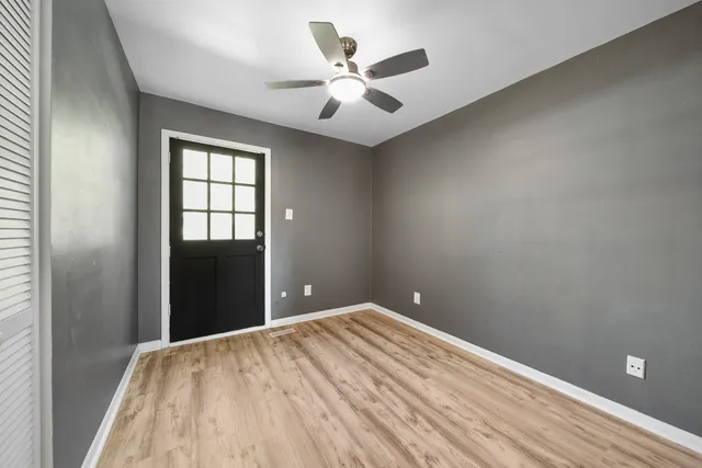 wooden floor in an empty room with a window