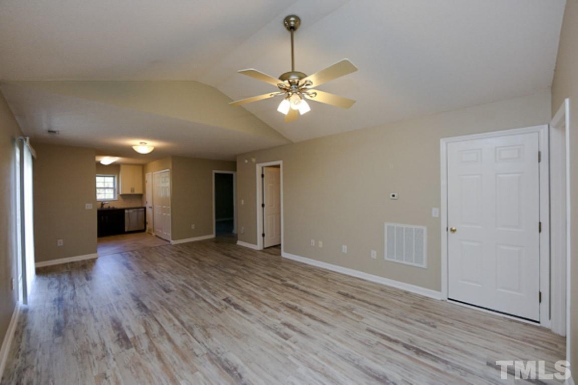 608 Edenberry Drive Durham, NC 27713 - Photo 2 of 14 a view of an empty room with window and wooden floor