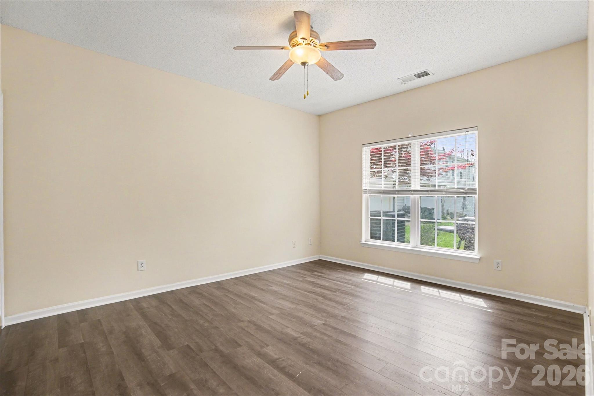 3315 Summerfield Ridge Lane Matthews, NC 28105 - Photo 11 of 27 wooden floor in an empty room with a window