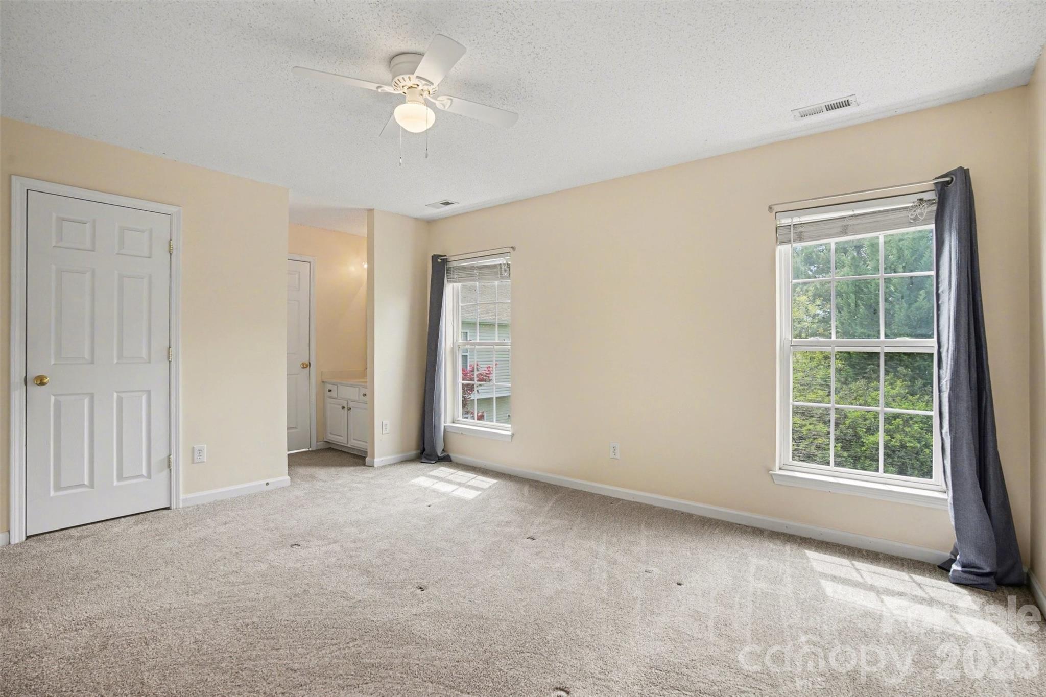 3315 Summerfield Ridge Lane Matthews, NC 28105 - Photo 14 of 27 an empty room with windows and fan