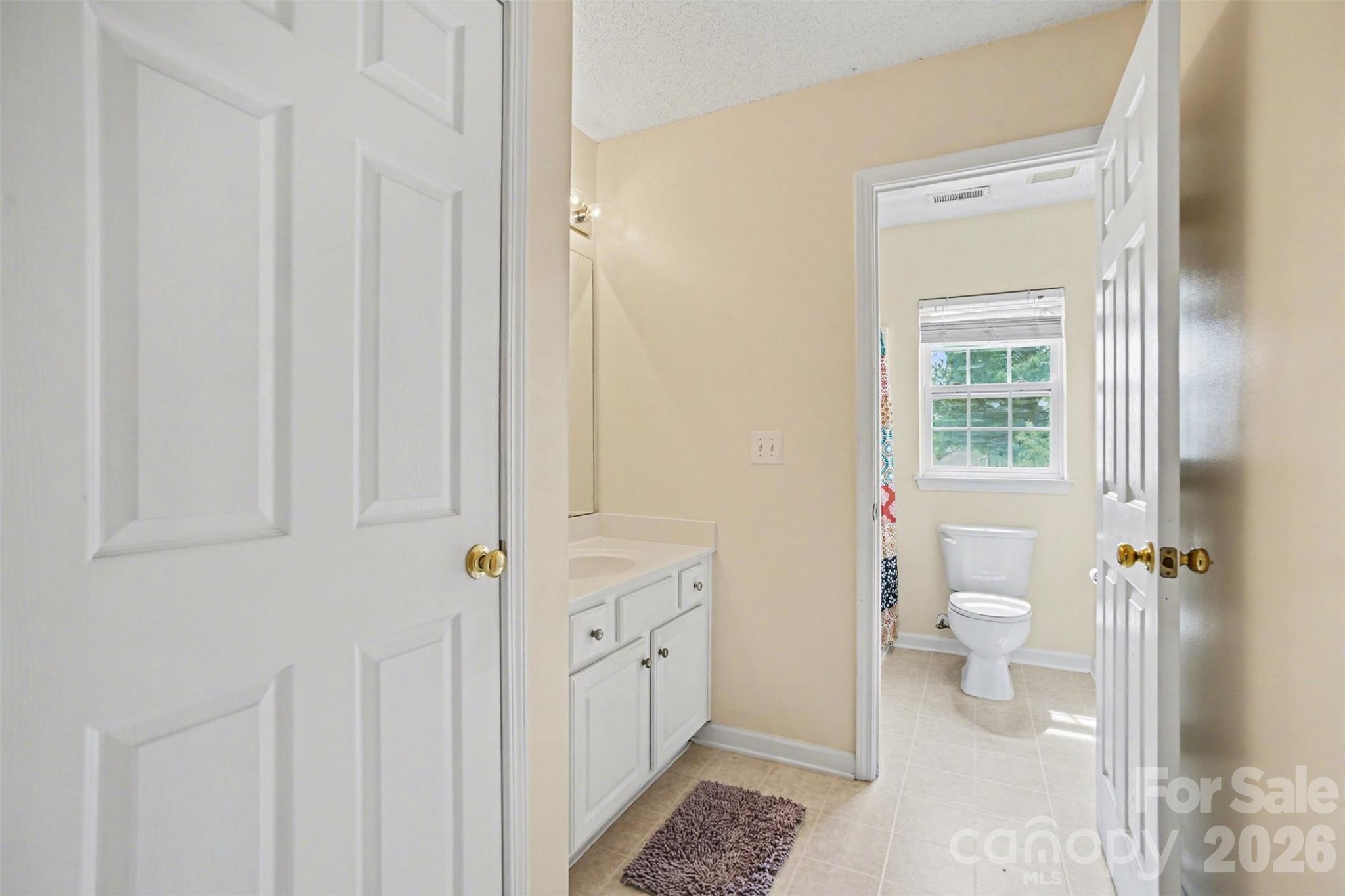 3315 Summerfield Ridge Lane Matthews, NC 28105 - Photo 19 of 27 a bathroom with a granite countertop sink a toilet and a shower
