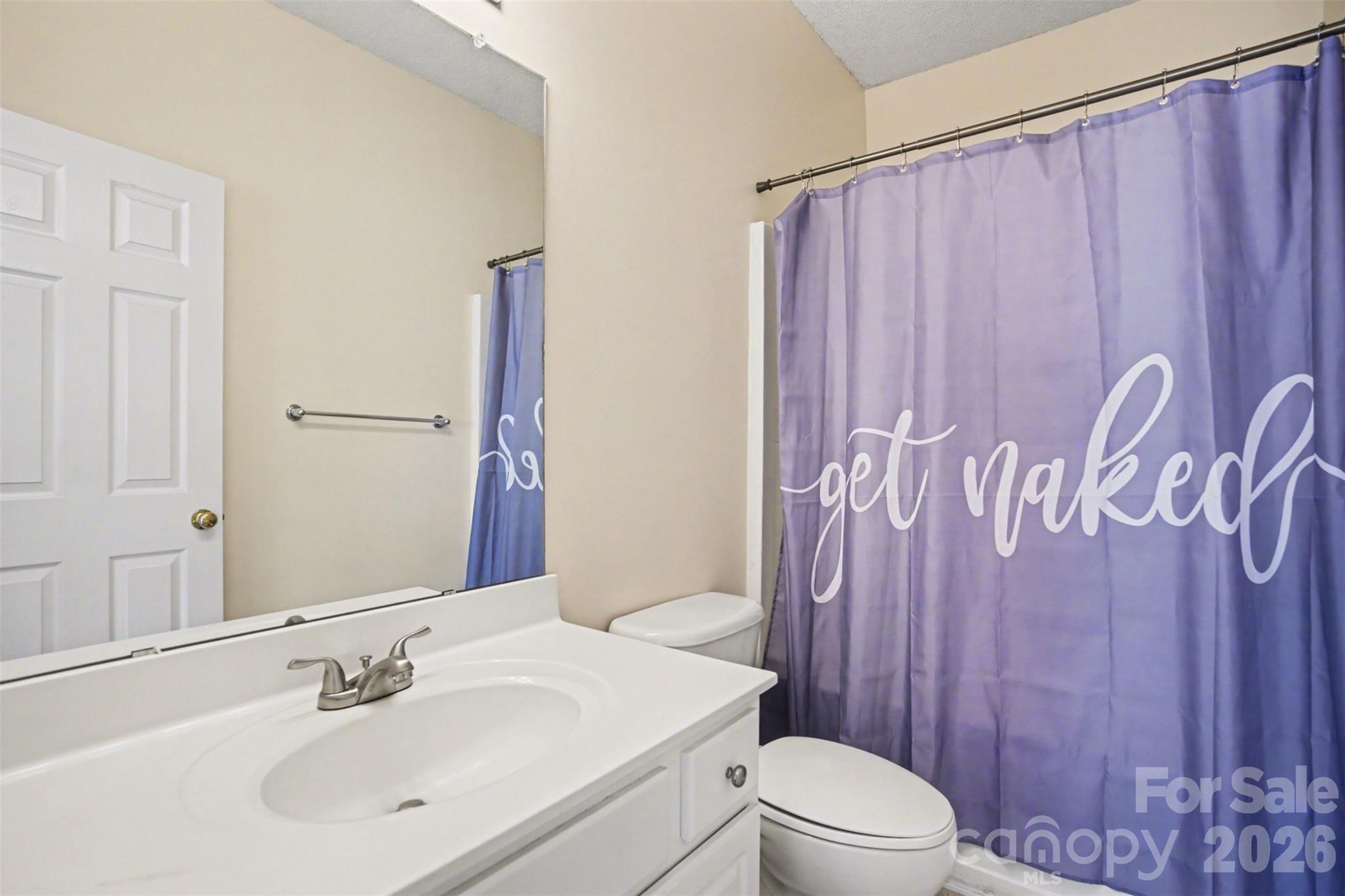 3315 Summerfield Ridge Lane Matthews, NC 28105 - Photo 22 of 27 a bathroom with a sink a toilet and shower curtain