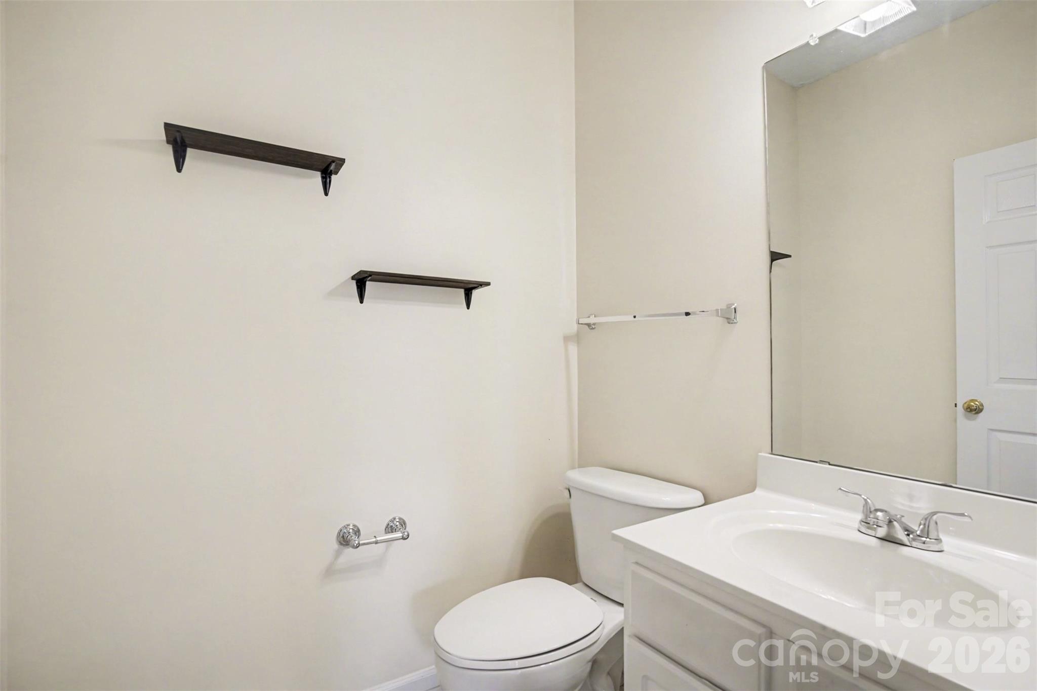 3315 Summerfield Ridge Lane Matthews, NC 28105 - Photo 23 of 27 a bathroom with a granite countertop sink toilet and a mirror