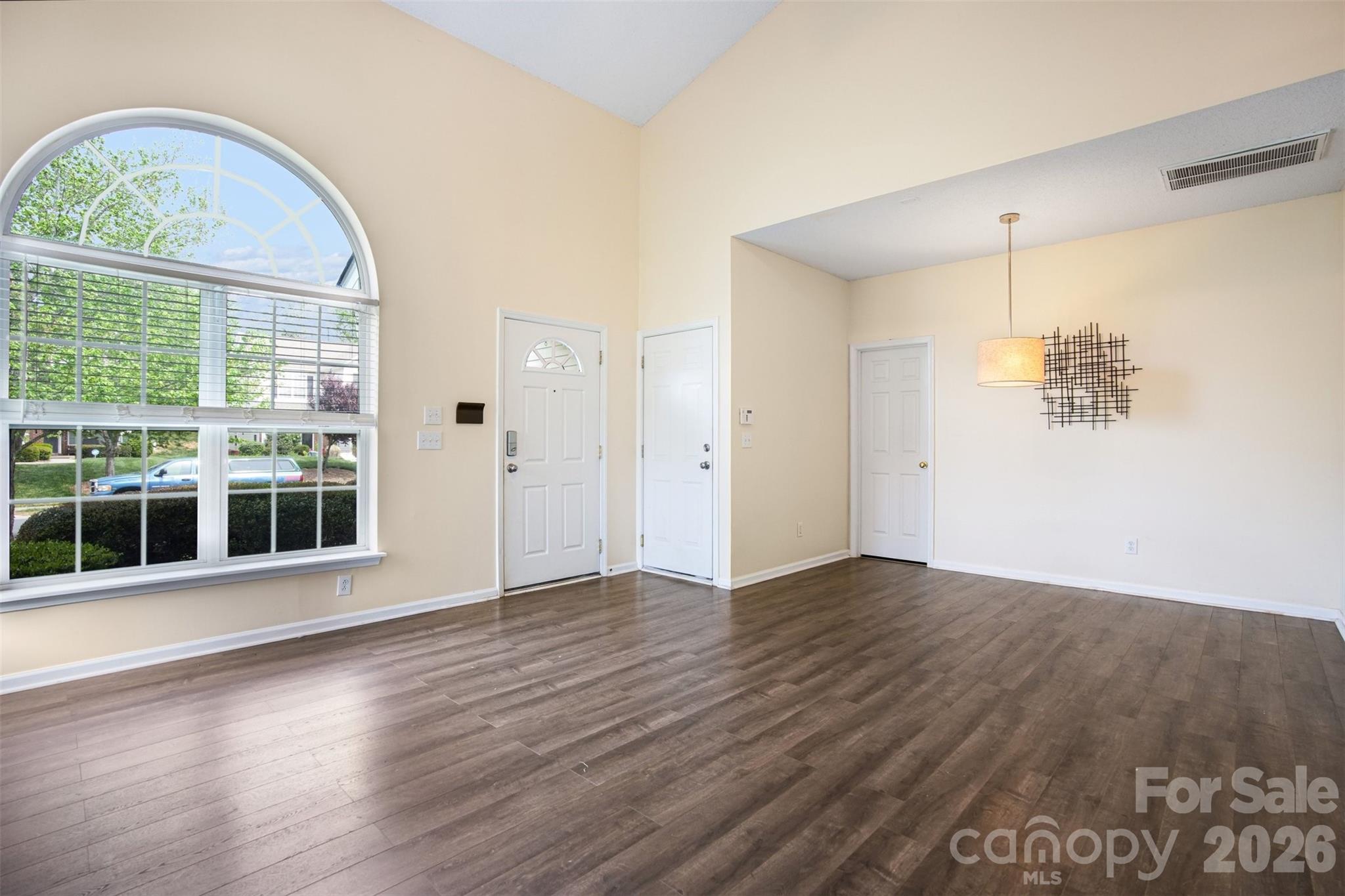 3315 Summerfield Ridge Lane Matthews, NC 28105 - Photo 3 of 27 an empty room with wooden floor and windows