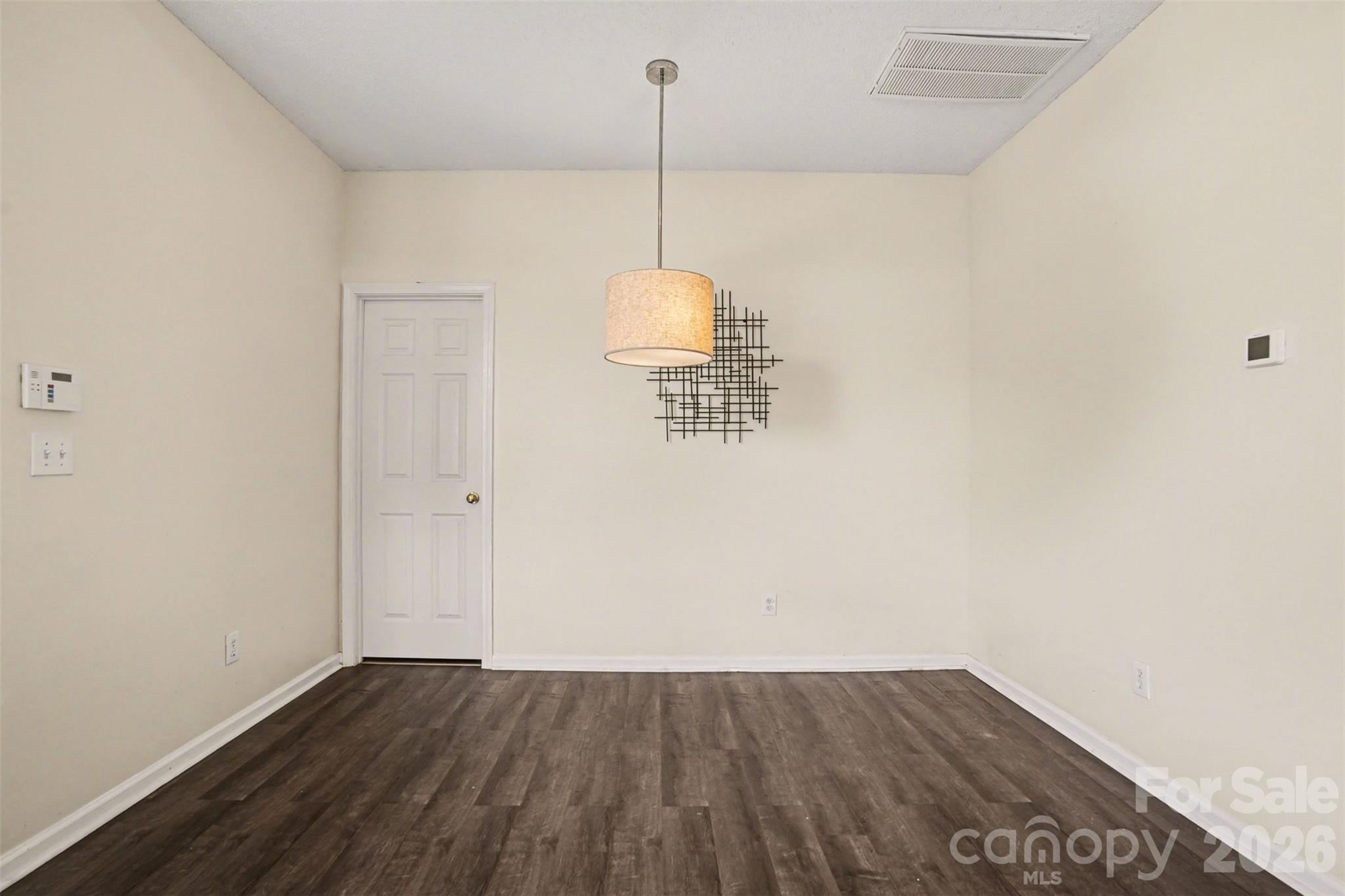 3315 Summerfield Ridge Lane Matthews, NC 28105 - Photo 4 of 27 a view of a room with wooden floor and ceiling fan