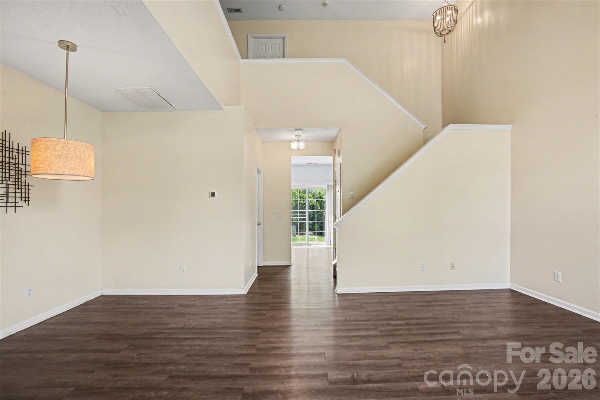 3315 Summerfield Ridge Lane Matthews, NC 28105 - Photo 6 of 27 a view of an empty room with wooden floor and a window