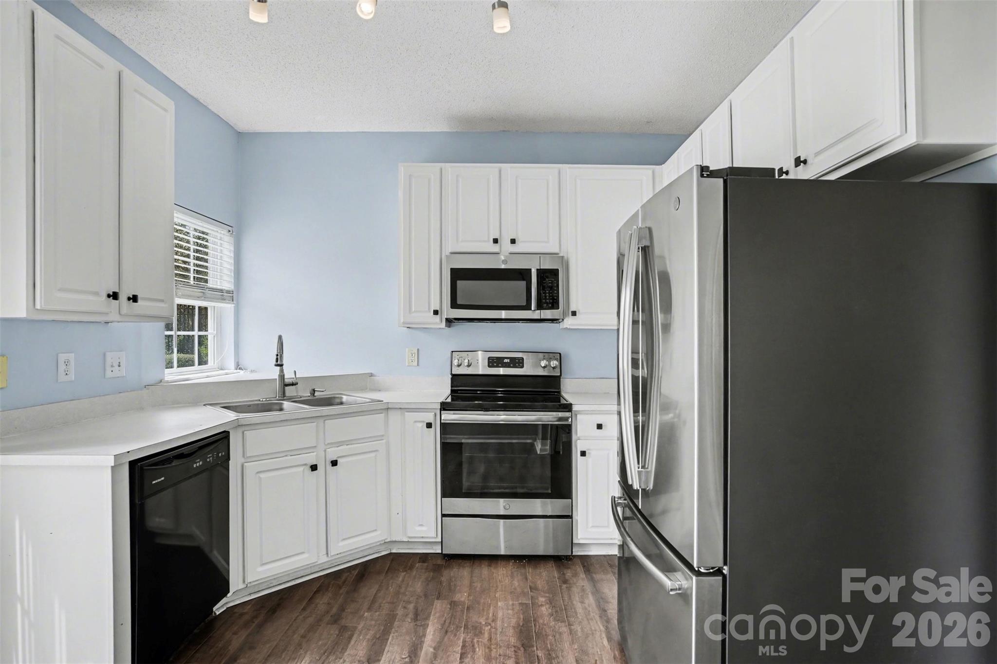 3315 Summerfield Ridge Lane Matthews, NC 28105 - Photo 10 of 27 a kitchen with stainless steel appliances a stove a sink and a refrigerator