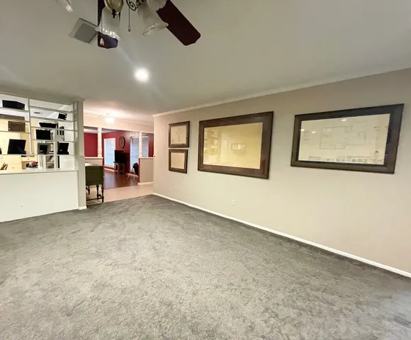 a view of a livingroom with furniture and a ceiling fan