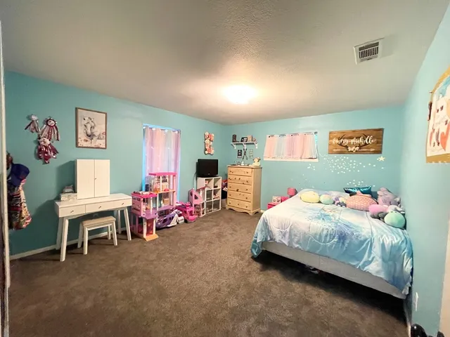 a bedroom with a bed and a table