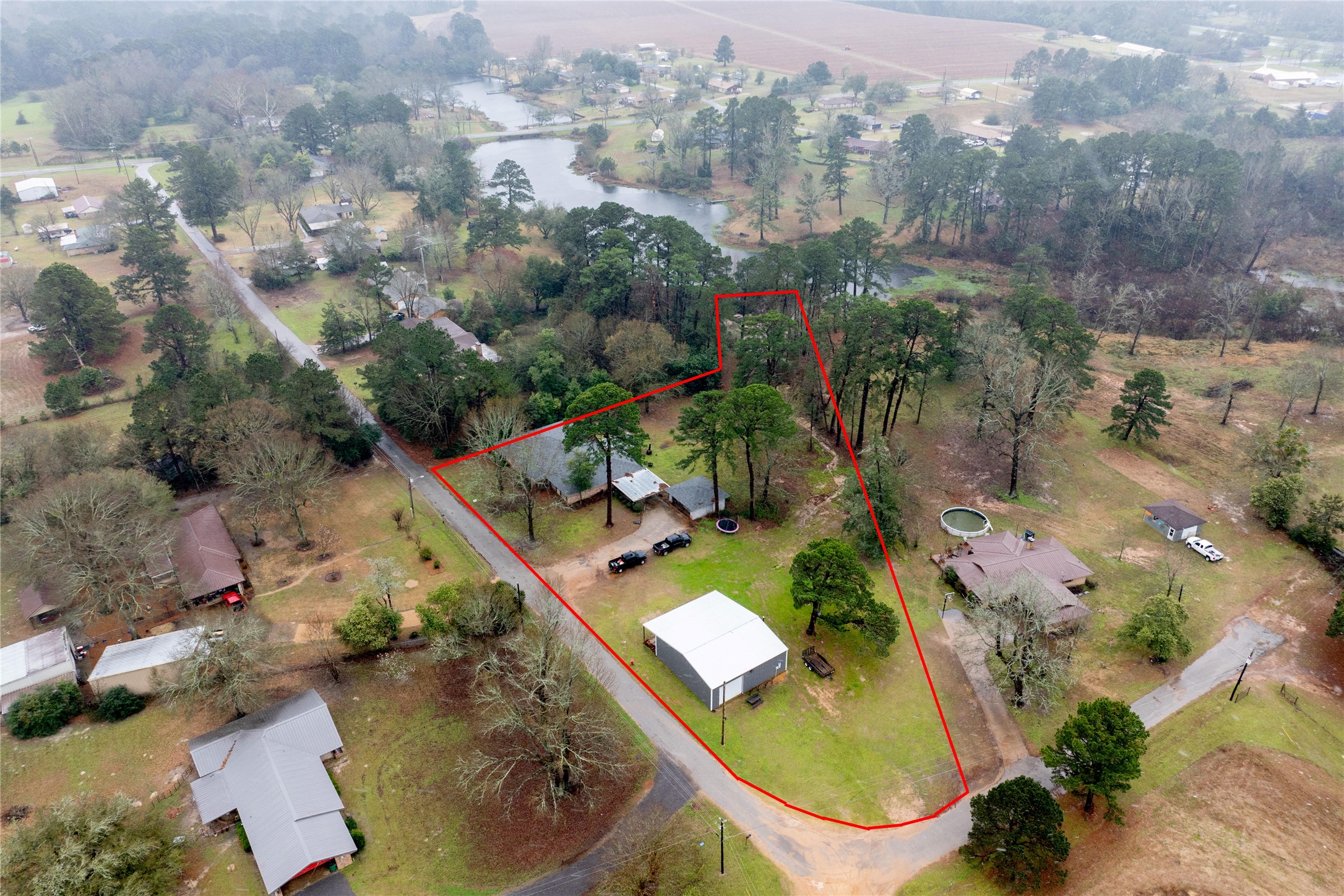 807 El Camino Road Grapeland, TX 75844 - Photo 2 of 34 an aerial view of a house with a yard and lake view