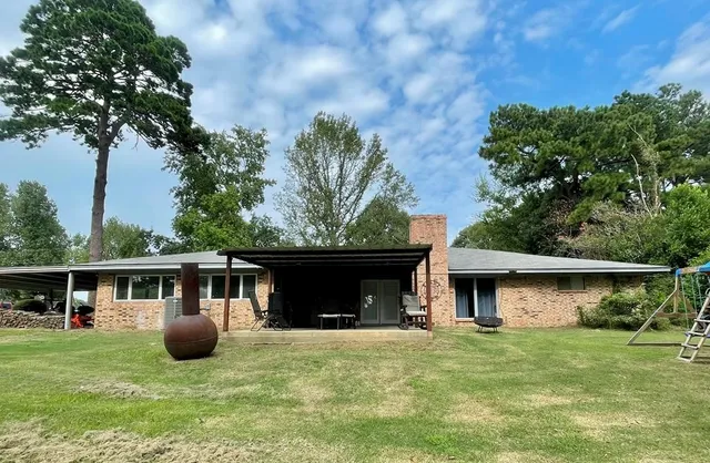 a view of house with backyard space and garden