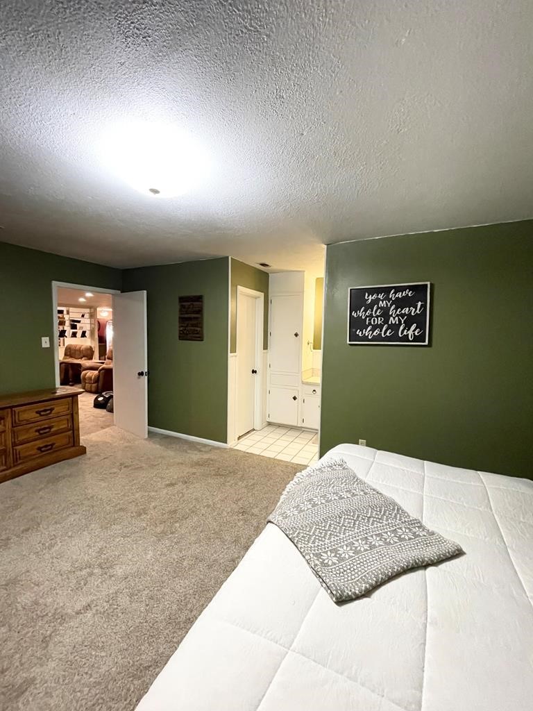 807 El Camino Road Grapeland, TX 75844 - Photo 33 of 34 a bedroom with a bed and a couch