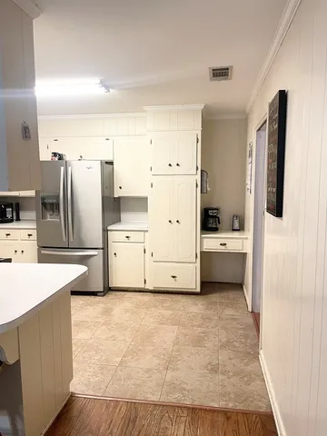 a kitchen with stainless steel appliances a refrigerator sink and cabinets