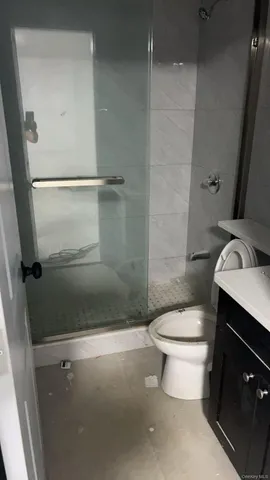 a bathroom with a toilet and a shower