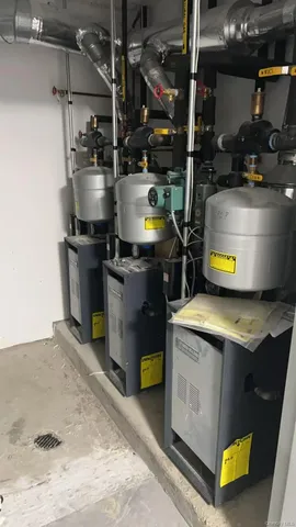 a kitchen with stainless steel appliances granite countertop a sink a stove and a refrigerator