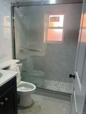 a bathroom with a toilet and a shower