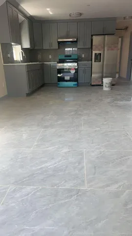 a kitchen with granite countertop a cabinets and stainless steel appliances