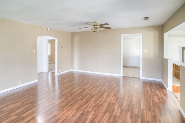 wooden floor in an empty room with a window