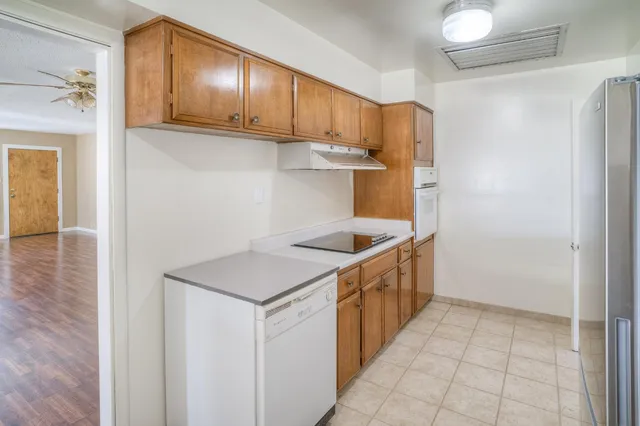 a kitchen with a sink and a refrigerator