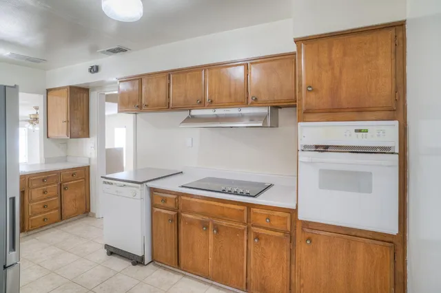 a kitchen with granite countertop cabinets and steel stainless steel appliances