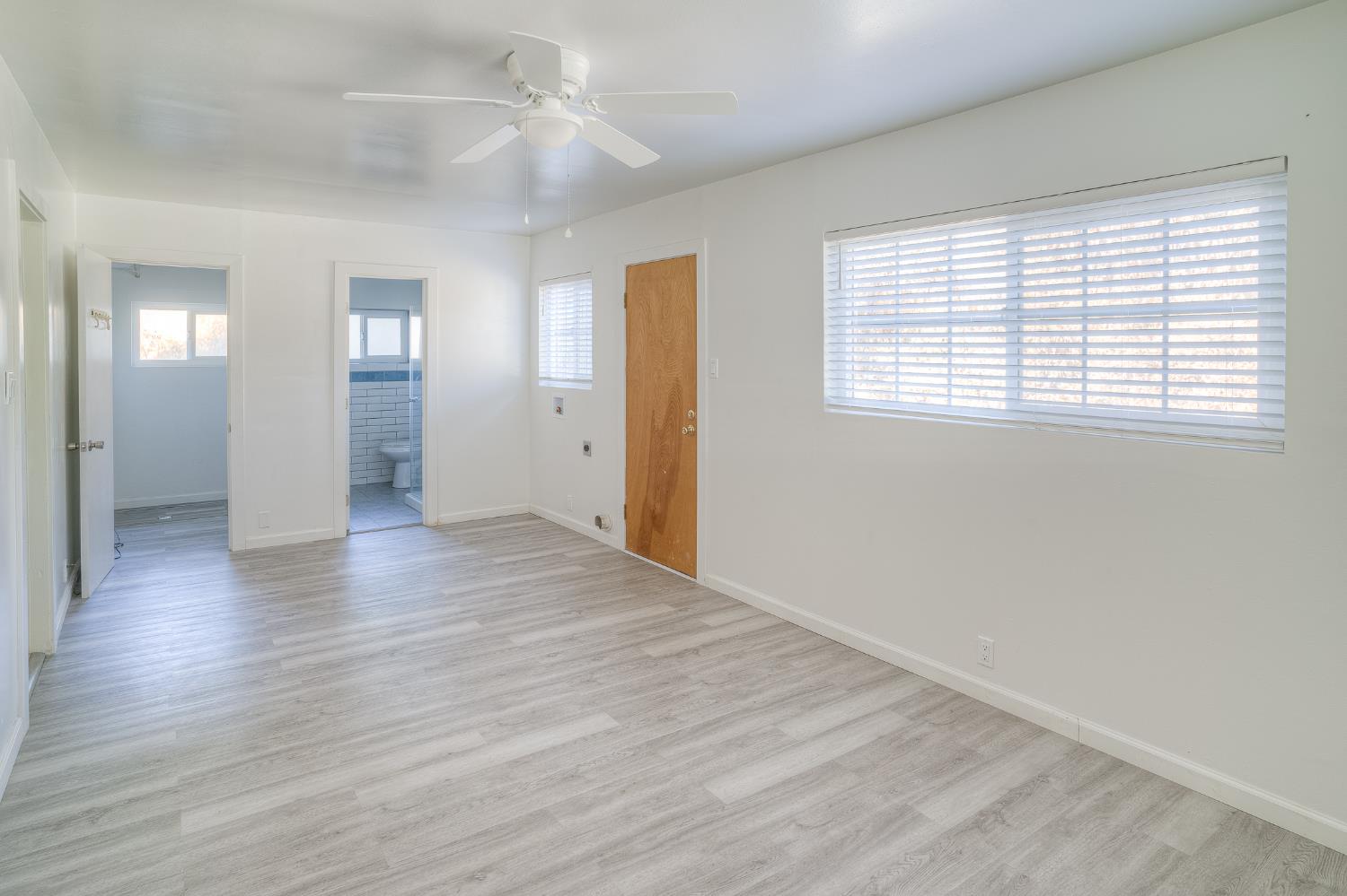 874 South Meridian Road Meridian, CA 95957 - Photo 17 of 54 a view of an empty room with wooden floor and a window