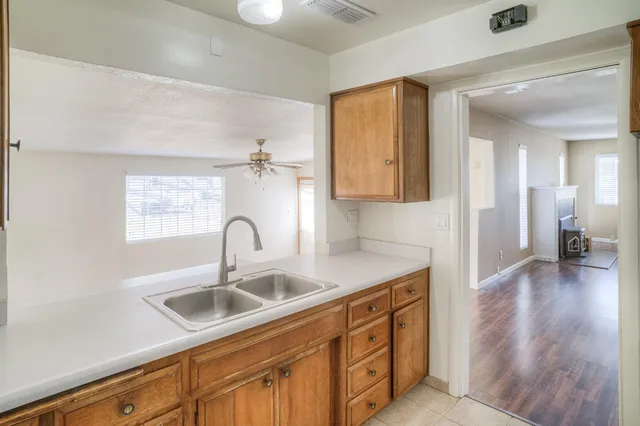 a kitchen with sink a faucet and wooden floor