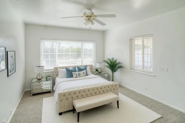 a bedroom with a bed and a chandelier