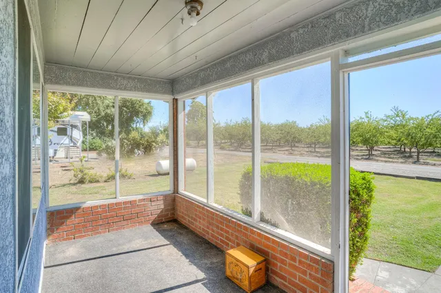 a view of swimming pool with seating area and trees around