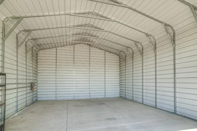 a view of a house with a backyard and a tree