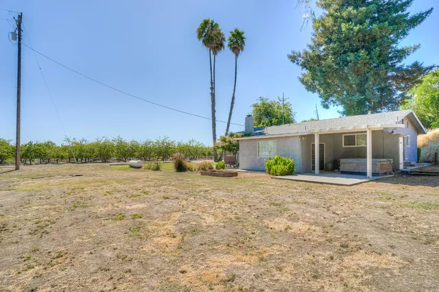a view of a house with a yard and a garage