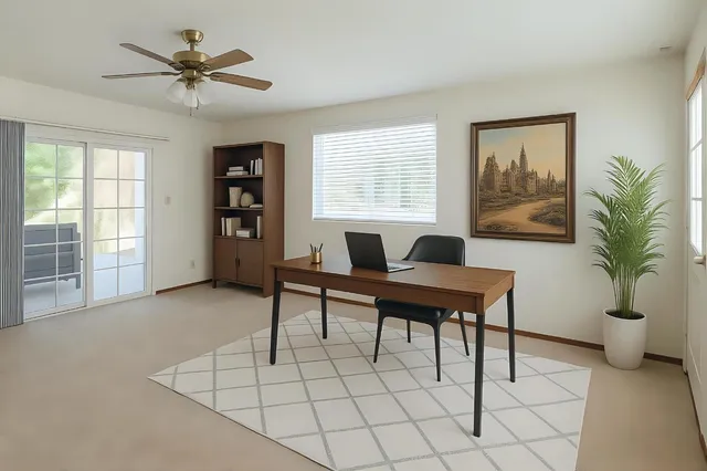 a living room with furniture a table and a potted plant