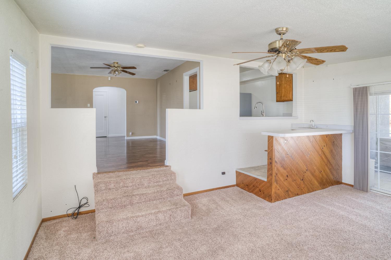 874 South Meridian Road Meridian, CA 95957 - Photo 10 of 54 a view of a livingroom with wooden floor and a ceiling fan
