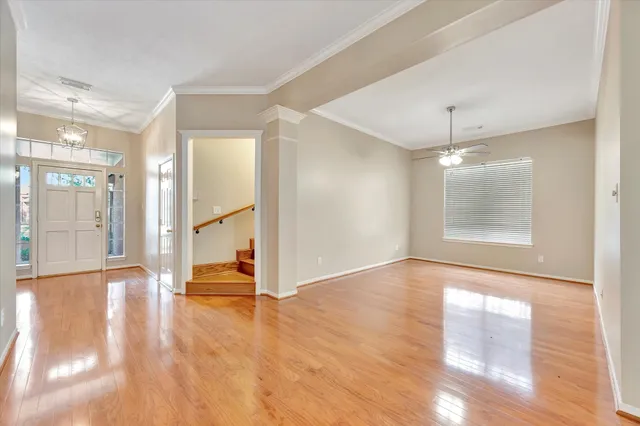 a view of an empty room with glass door and windows