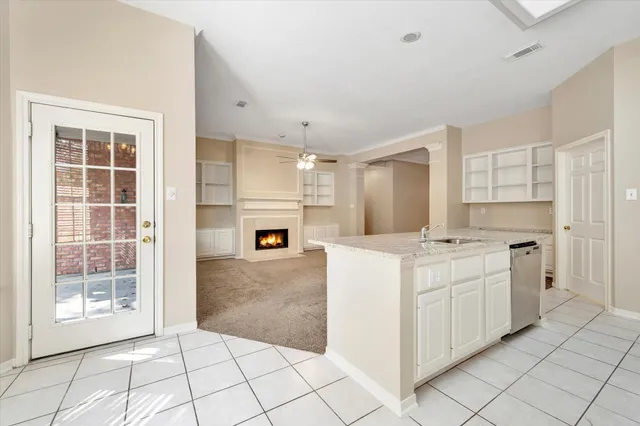 a kitchen with white cabinets a sink and white appliances