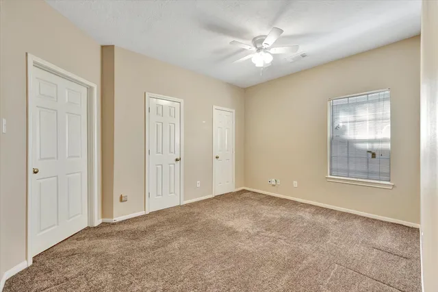an empty room with windows and closet