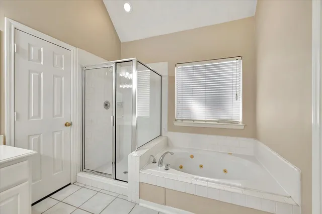 a bathroom with a tub a sink and a shower