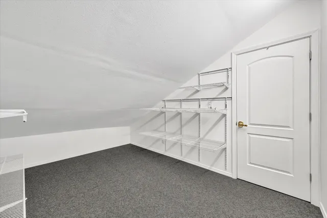 a view of a kitchen with white cabinets