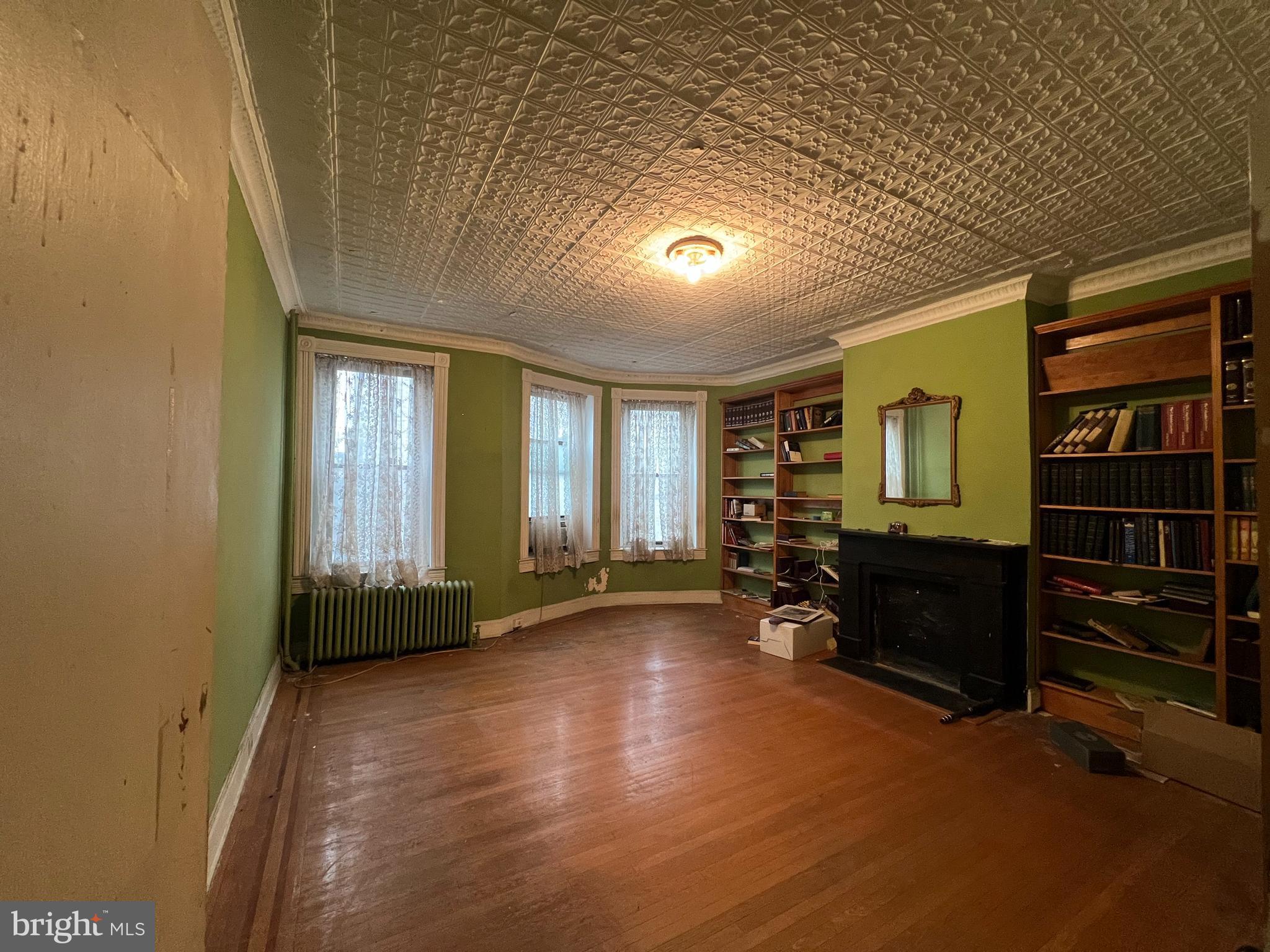 1908 Madison Avenue Baltimore, MD 21217 - Photo 17 of 31 wooden floor in an empty room with a window
