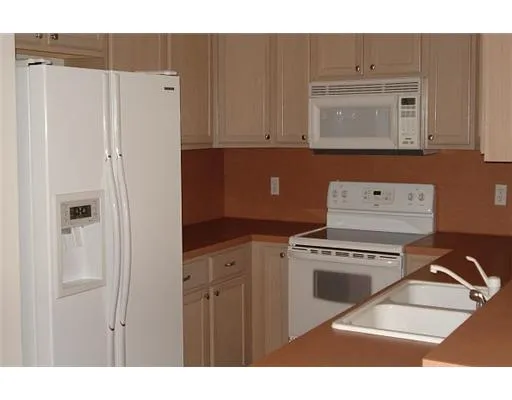 a kitchen with a cabinets and white appliances