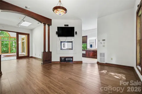 a view of a livingroom with furniture flat screen tv and wooden floor