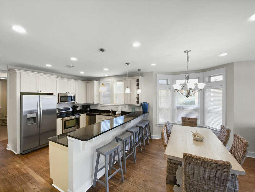 141 Lifeguard Loop East Inlet Beach, FL 32461 - Photo 11 of 40 a kitchen with refrigerator and chairs