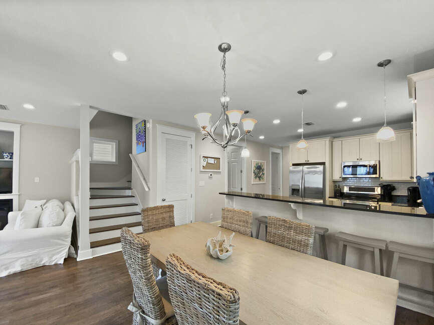 141 Lifeguard Loop East Inlet Beach, FL 32461 - Photo 13 of 40 a kitchen with kitchen island granite countertop a sink cabinets and wooden floor